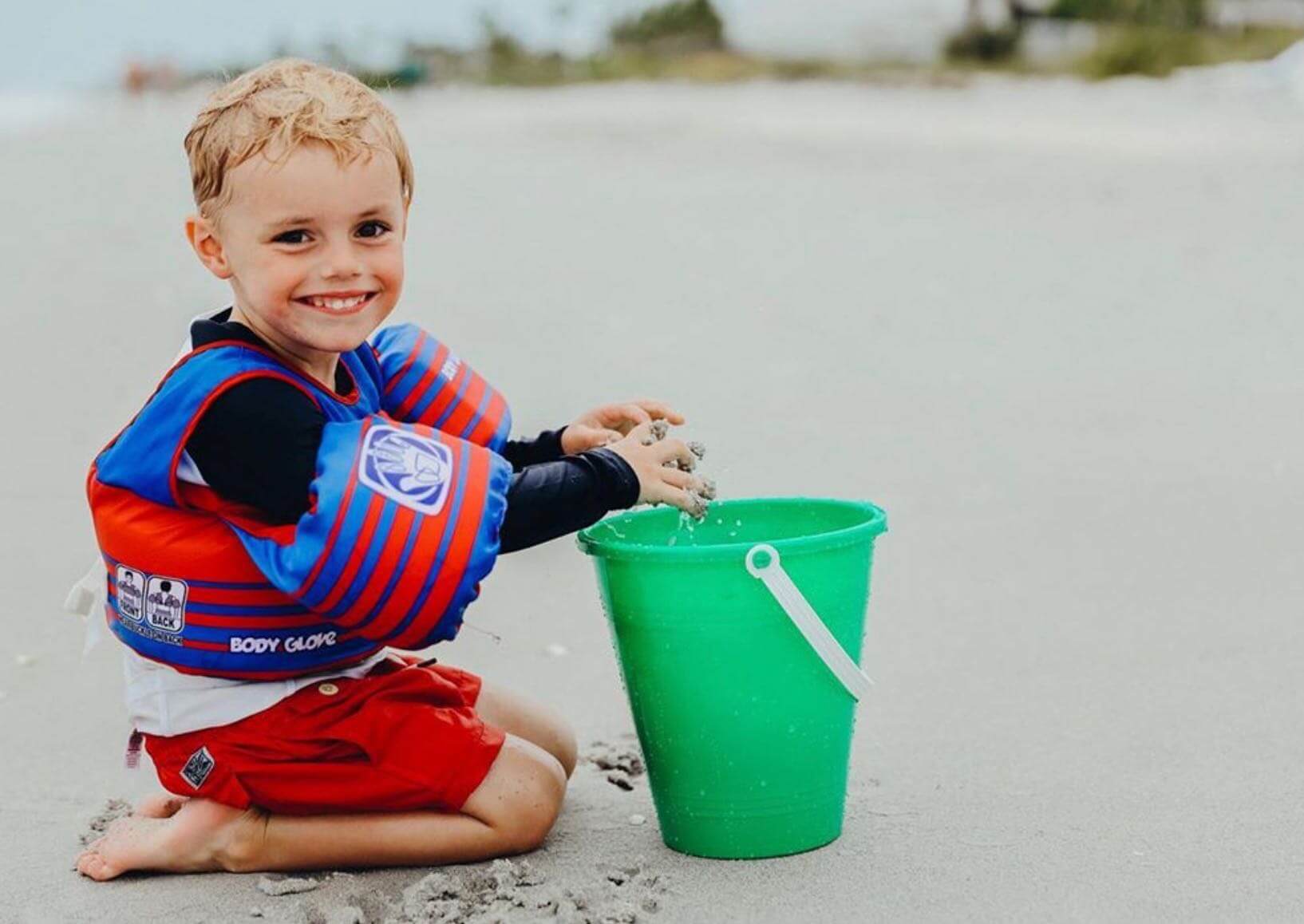 boy plays in shore on sanibel beach