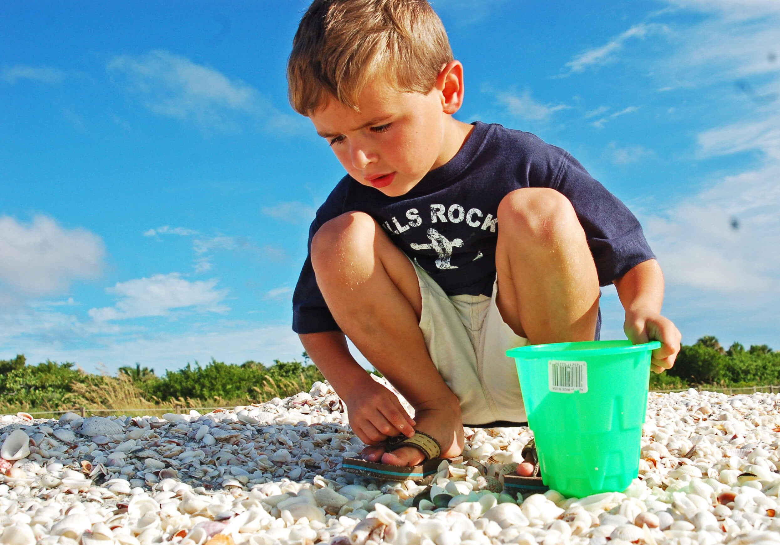 sanibel-island-hotels-island-inn-guest-shelling-Jim-Rand Child searching for shells on the beach