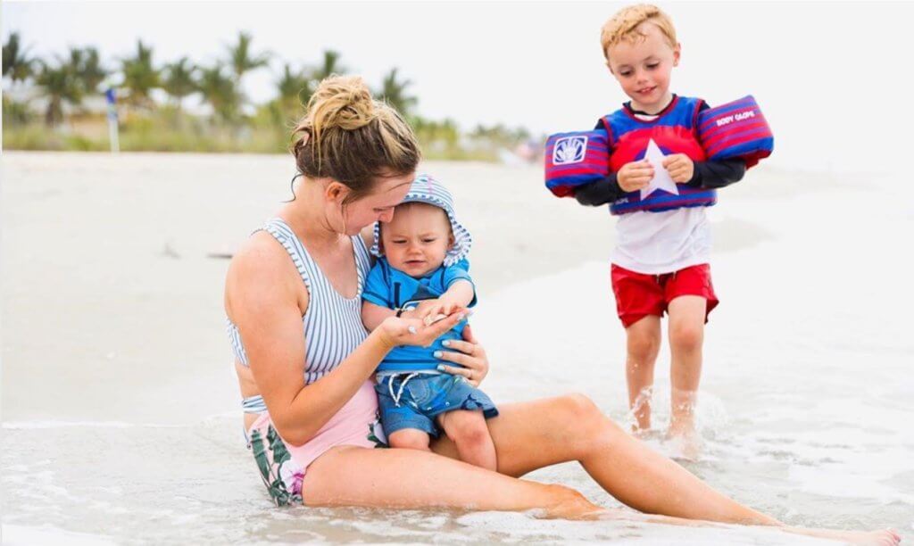mom plays with sons on sanibel beach