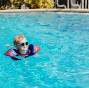 boy swims in island inn pool