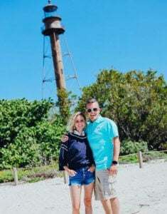 couple poses in front of sanibel lighthouse