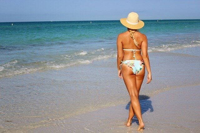 Woman walking on a Sanibel Island beach | What airport is closest to Sanibel Island and Island Inn? | Island Inn